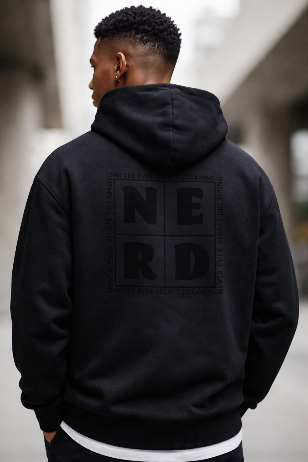 Back view of black NERD hoodie with Never Ever Regret Dreaming graphic
